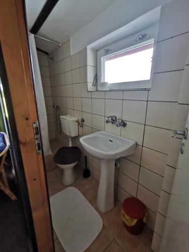 a small bathroom with a sink and a toilet at Ośrodek Wypoczynkowy "U Kulasa" in Warchały