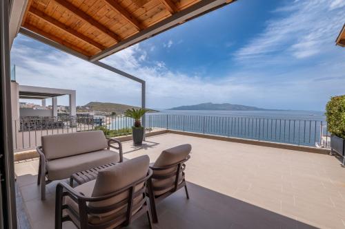 a balcony with chairs and a view of the ocean at Franklin Rooms in Sarandë