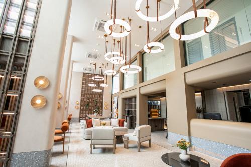 a lobby of a building with chandeliers at Pillow B Hotel in Ban Zong Katiam