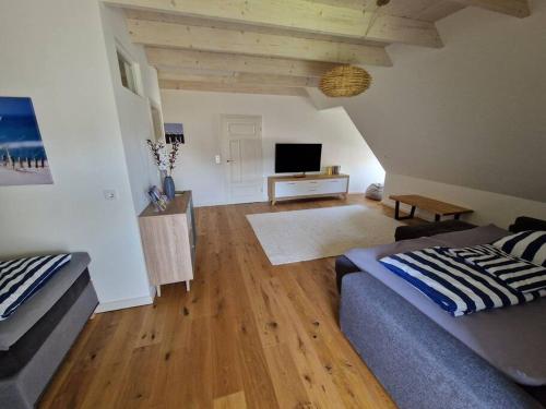 a living room with a couch and a television at Ferienwohnung Friesenwind in Rantrum