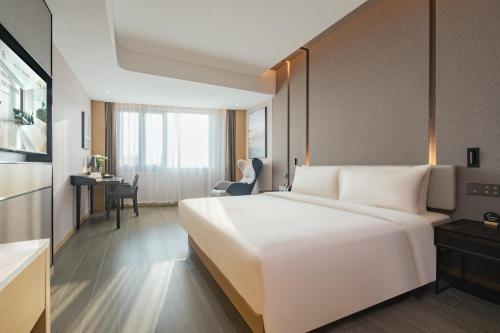 a large white bed in a hotel room at Atour Hotel Shanghai Jiading Juyuan Wisdom Center in Jiading