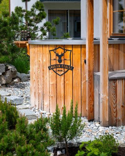 a wooden fence with a wolf sign on it at Engadin Chalet - Private Spa Retreat & Appart -St Moritz - Val Bever in Bever