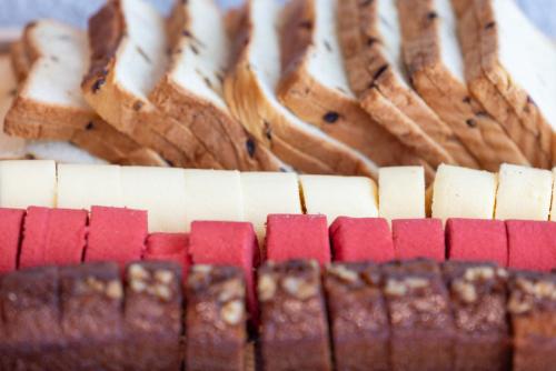 a close up of a cake with cheese and bread at Atour Light Hotel Shanghai Daning International Shibei High-tech Park in Shanghai