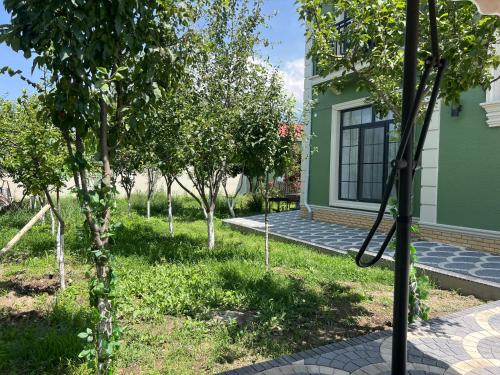 a row of trees in front of a house at Luxury Villa in Ismayilli in İsmayıllı