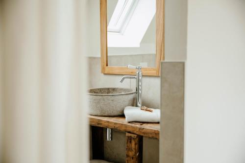 a bathroom with a sink and a mirror at Les Bucoliques de la Noë in Goven