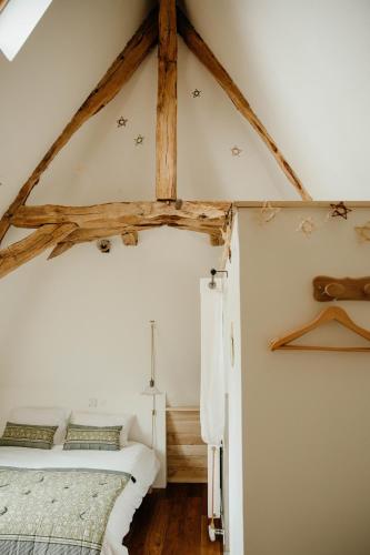 a bedroom with two beds in a attic at Les Bucoliques de la Noë in Goven