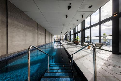 a swimming pool with stairs in a building at Richmond Apartments with Urban Rest in Melbourne