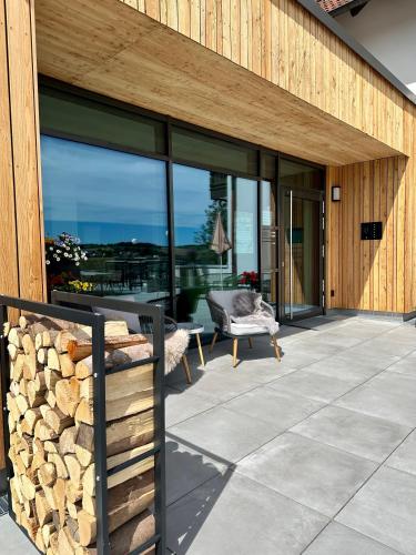 a patio with a stack of fire wood next to a building at Landgasthof Linden in Linden