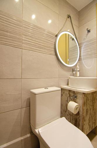 a bathroom with a white toilet and a mirror at Kefalonian Luxury Villas in Kástron