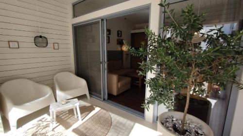 a room with a table and chairs and a glass door at Casinha Secreta - A Gema Escondida da Santa Luzia in Santa Luzia