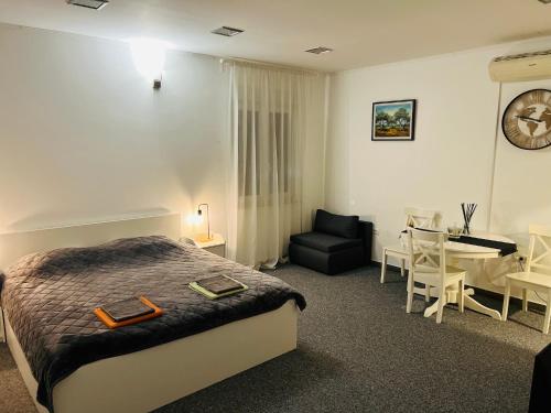 a bedroom with a bed and a table and a chair at WHOLE HOUSE FOREST-yard and BBQ, private parking in Marinići