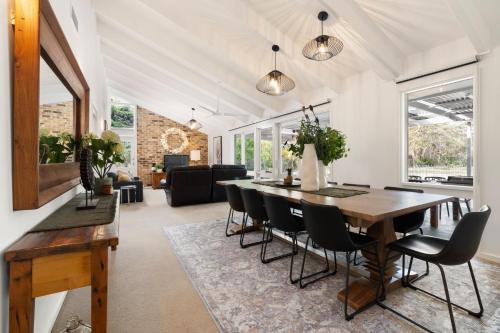 a dining room with a table and chairs at 'Avondale' Luxe Country Retreat in Pitt Town
