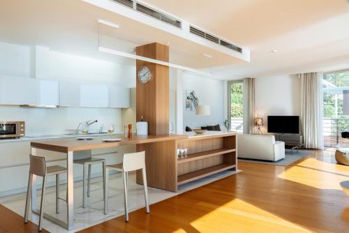 a kitchen with a table and chairs and a living room at Luxury Waterfront Villa at Dukly Gardens in Budva