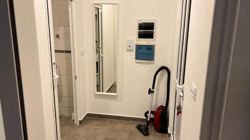 a bathroom with a mirror and a red suitcase at WHOLE HOUSE FOREST-yard and BBQ, private parking in Marinići