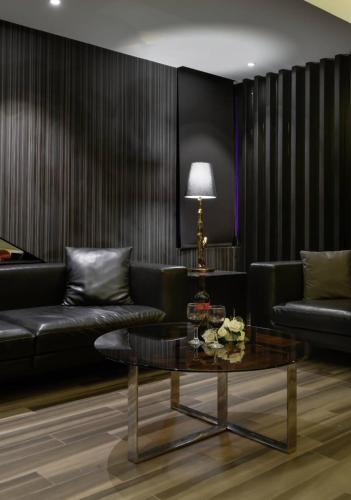 a living room with a couch and a table at M Hotel in Caotun