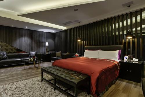 a bedroom with a bed and a living room at M Hotel in Caotun