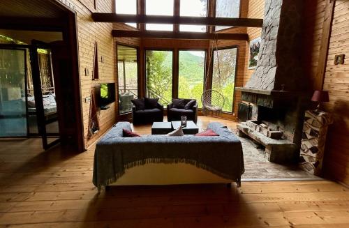a living room with a couch and a fireplace at ❆cozy, 4 BR. Villa in Ananuri❆ in Ananuri