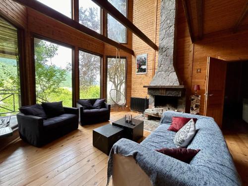 a living room with a couch and a fireplace at ❆cozy, 4 BR. Villa in Ananuri❆ in Ananuri