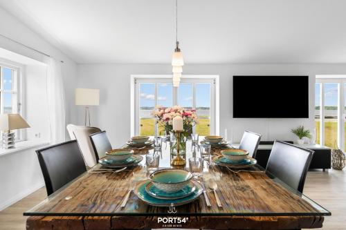ein Esszimmer mit einem Holztisch mit Stühlen in der Unterkunft Ferienhaus Loft an der Ostsee Glücksburg in Glücksburg