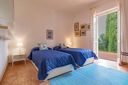 duas camas em um quarto com uma janela grande em Tenuta Bussadori - Casa Del Maresciallo em Poggio