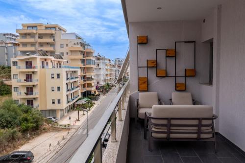 a balcony with chairs and a view of a city at Franklin Rooms in Sarandë