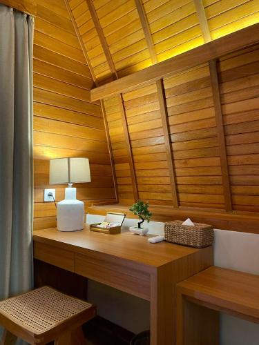 a desk in a room with wooden walls and ceilings at Abian Klumpu Villa & Spa Sanur Bali in Sanur
