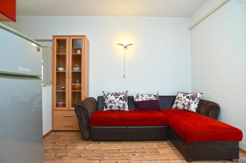 a living room with a couch with a red blanket at Apartments Magdalena 759 in Valbandon