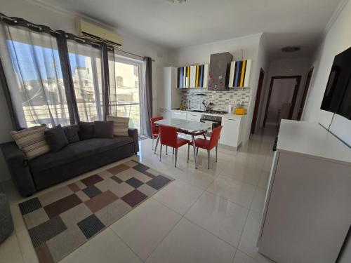 a living room with a couch and a table at Stunning two bed apartment in St Pauls Bay Malta in St Paul's Bay