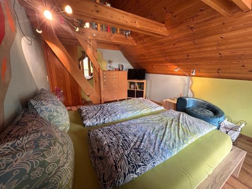 a bedroom with a bed and a couch in a room at B&B Stein am Rhein in Stein am Rhein