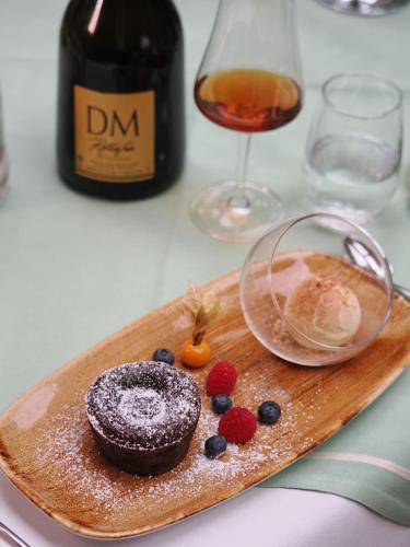 a plate of food on a table with a bottle of wine at Forsthaus Langenberg in Bansin