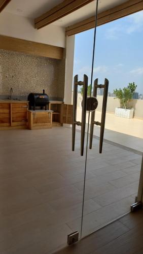a room with a glass door with a view of a kitchen at Addis Ville Hotel Apartment in Addis Ababa