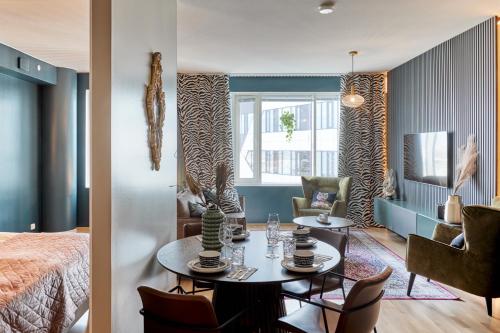 a hotel room with a bed and a table and chairs at Magnificent luxury for you in Tampere