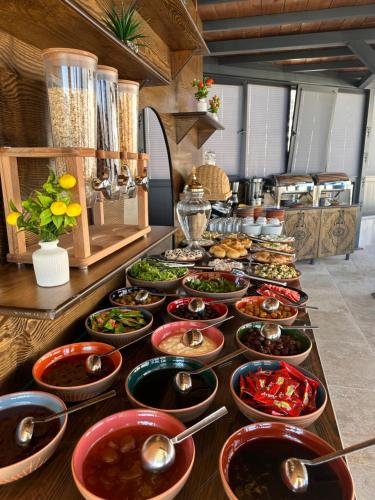 a buffet with many bowls of food on a table at Hira Cave Hotel in Goreme