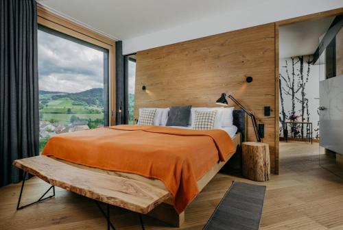 a bedroom with a large bed and a large window at Luisenhöhe - Gesundheitsresort Schwarzwald in Horben