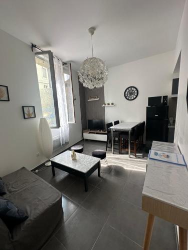 un salon avec un canapé et une table dans l'établissement Le petit Narbonnais à 4min à pied de la gare, à Narbonne