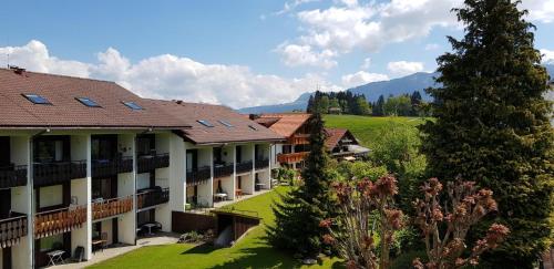 a view of a resort with mountains in the background at Haus Obermaiselstein in Obermaiselstein