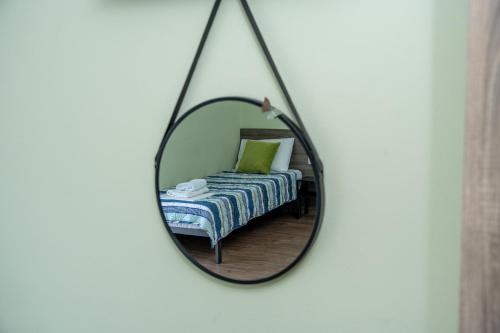 a mirror with a bed in a room at Villa Olympia in Paralia Katerinis