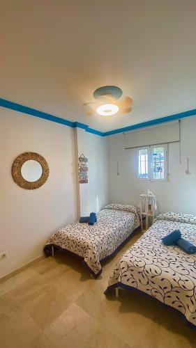 a room with two beds and a mirror at Loving Mediterranean Home in Estepona