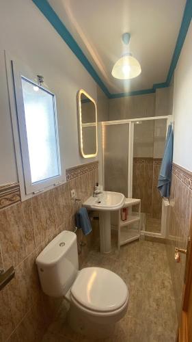 a bathroom with a toilet and a sink at Loving Mediterranean Home in Estepona