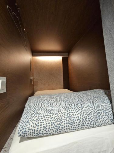 a bedroom with a bed with a wooden head board at Seoul Cube Myeongdong in Seoul