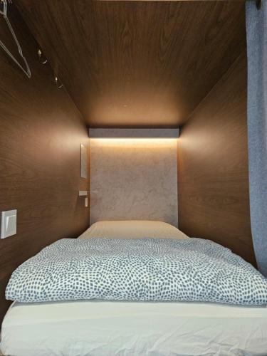 a bedroom with a bed with a wooden head board at Seoul Cube Myeongdong in Seoul