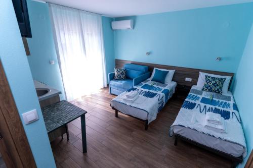 a room with two beds and a couch at Villa Olympia in Paralia Katerinis