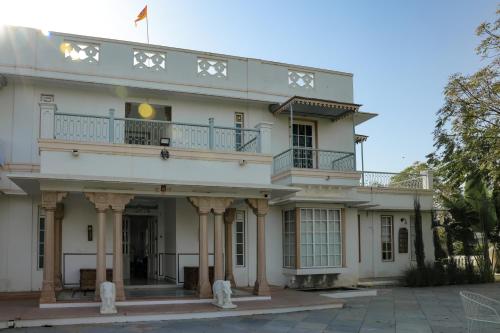 a white building with a balcony on top of it at Naila Kothi - A Luxury Boutique Royal Suites in Jaipur in Jaipur