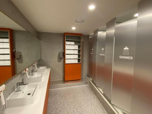 a bathroom with two sinks and a red door at Seoul Cube Myeongdong in Seoul