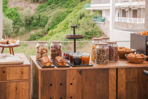 a table with many jars of food on it at Thetis Boutique Apartments in Neos Marmaras