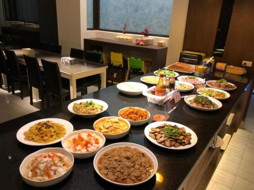 a table with many bowls of food on it at M Hotel in Caotun