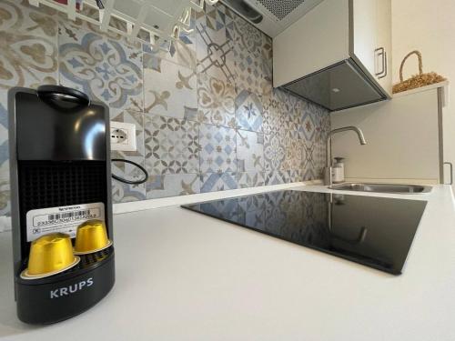 a kitchen with a coffee maker on a counter at Casetta Amati in Nettuno