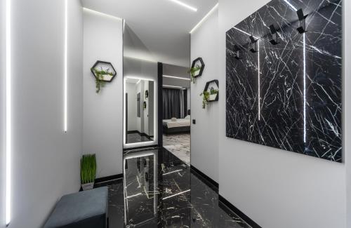 a bathroom with black and white marble walls and a mirror at Luxury apartments GREAT in Kyiv