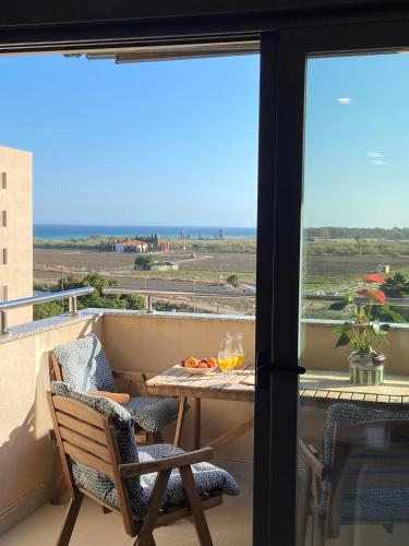 a balcony with a table and chairs and a view of the ocean at LA MARINA in Torre del Mar