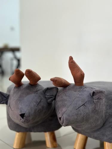 two stuffed animals are sitting on wooden posts at Mojisu Homestay 麻吉宿 in Miri